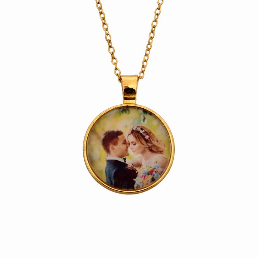 Gold necklace with a round pendant featuring an image of two people.