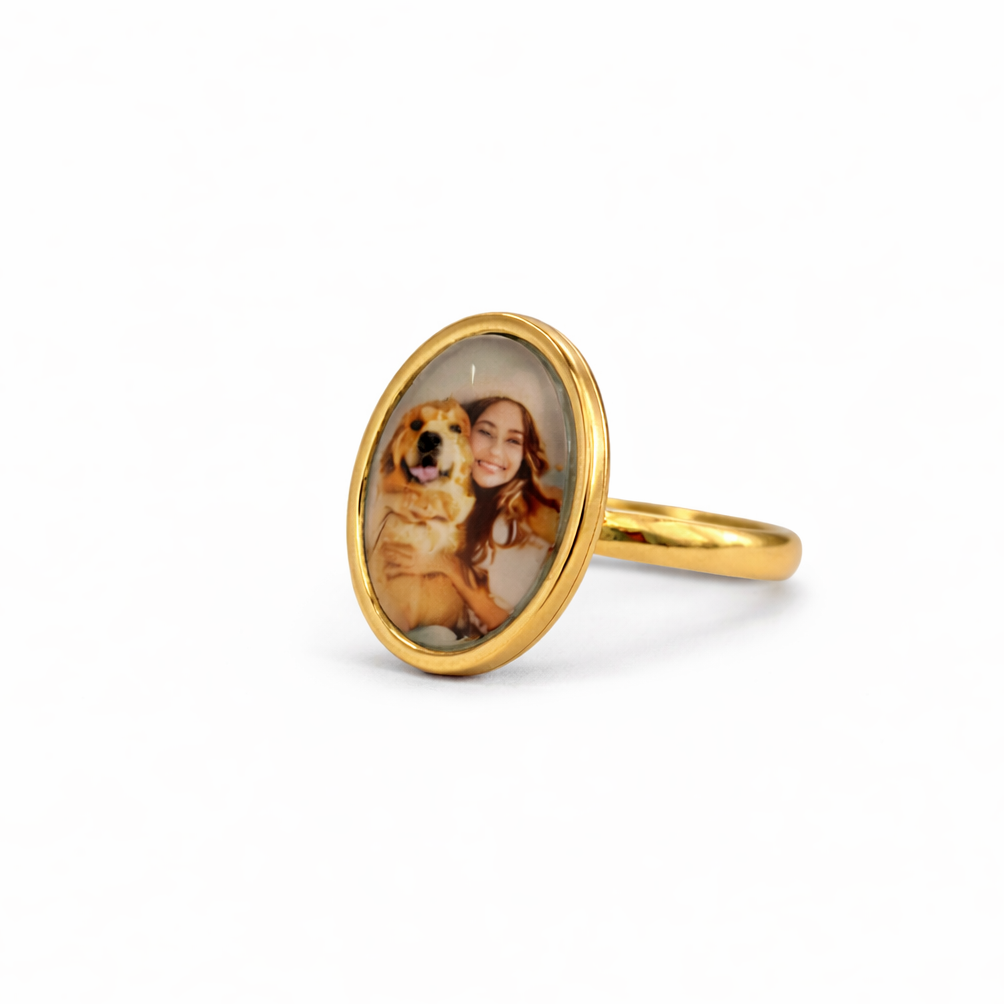 Gold ring with a photo of a woman and dog on a white background