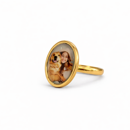 Gold ring with a photo of a woman and dog on a white background