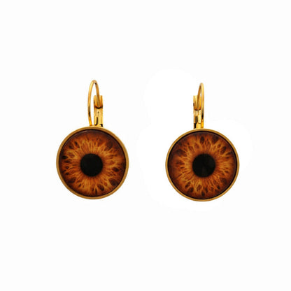 Pair of gold earrings with brown and black eye design on a white background