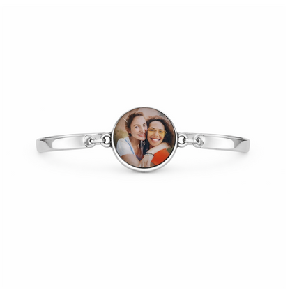 Silver bracelet with a round photo charm featuring two people on a white background
