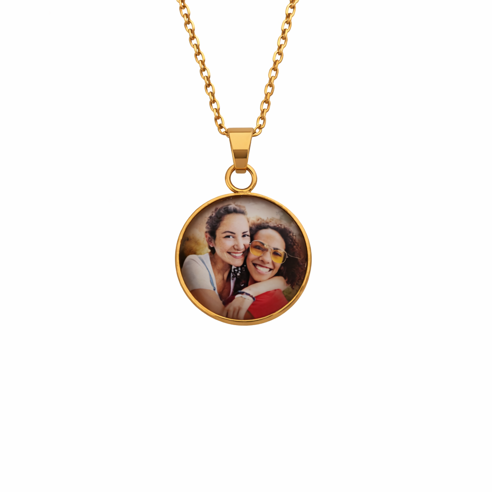 Gold necklace with a round pendant featuring a photo of two people on a white background