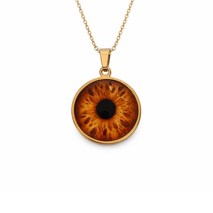 Gold necklace with an eye-shaped pendant on a white background